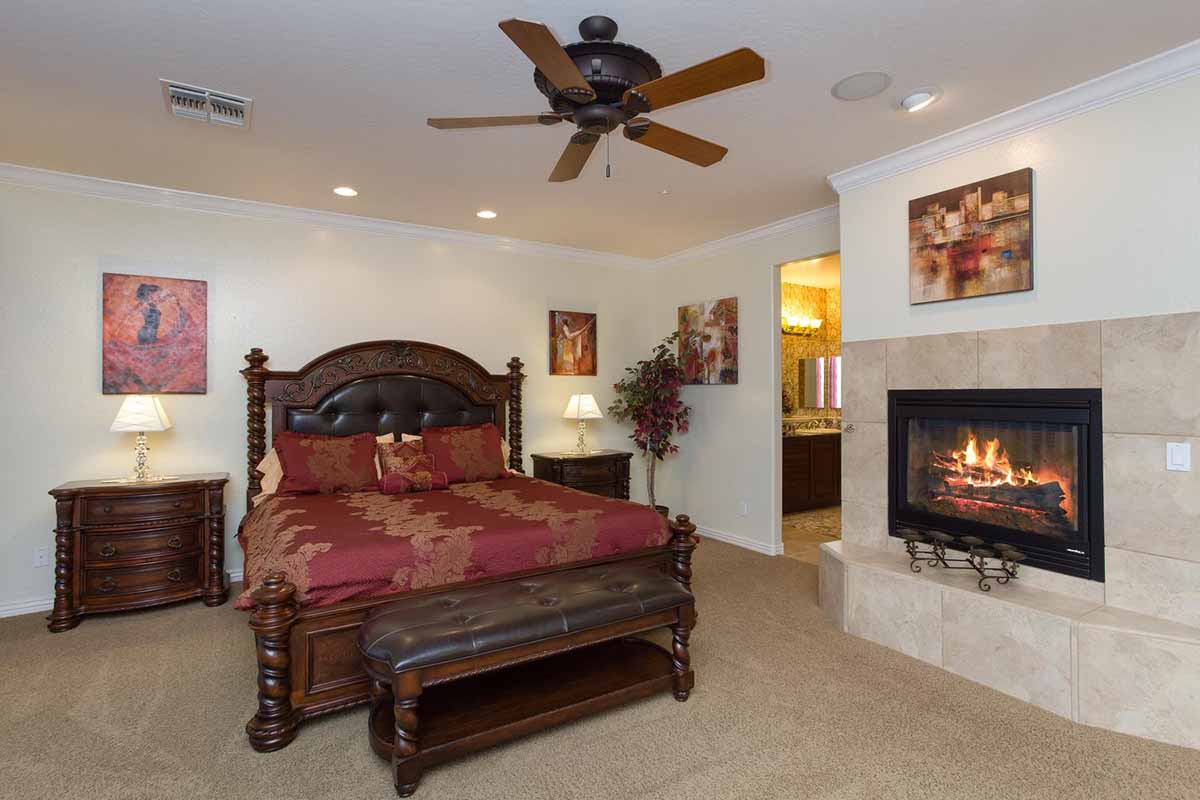 Master bedroom with King size bed and fireplace