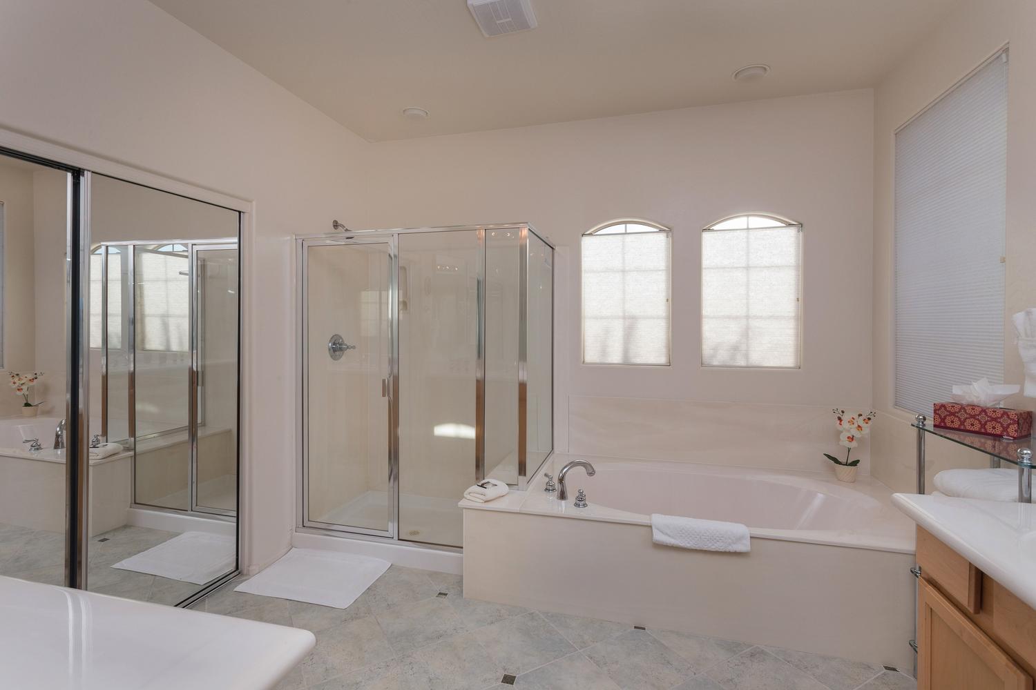 Master bath with separate, shower, tub, double sink and large attached walk-in closet